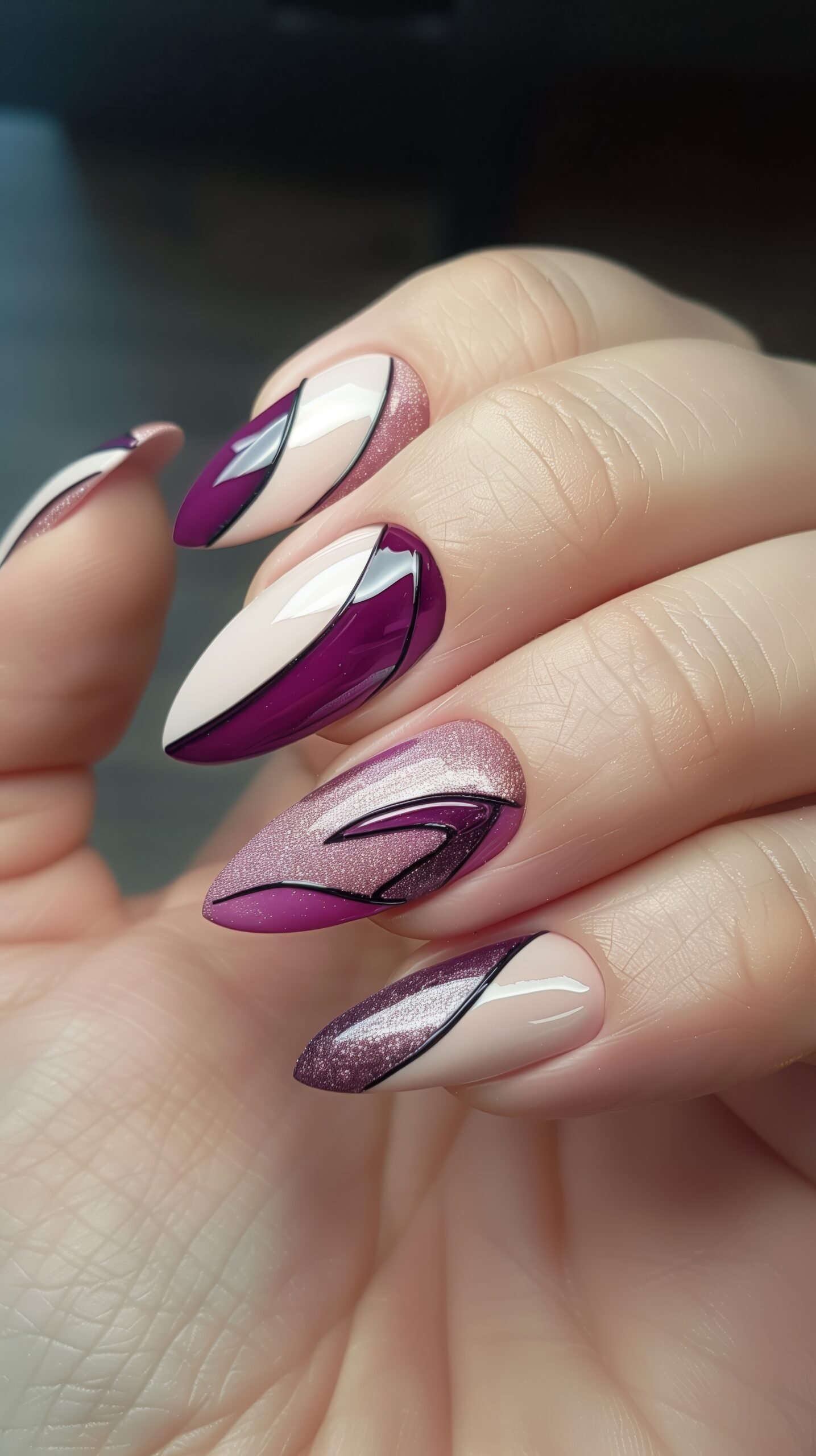 Nail art of purple and gradient geometric pattern. Close-up view of a hand with long, stiletto-shaped nails painted in a purple and white colors. High quality beautiful manicure